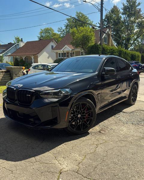 Black BMW X4 M with dark window tint